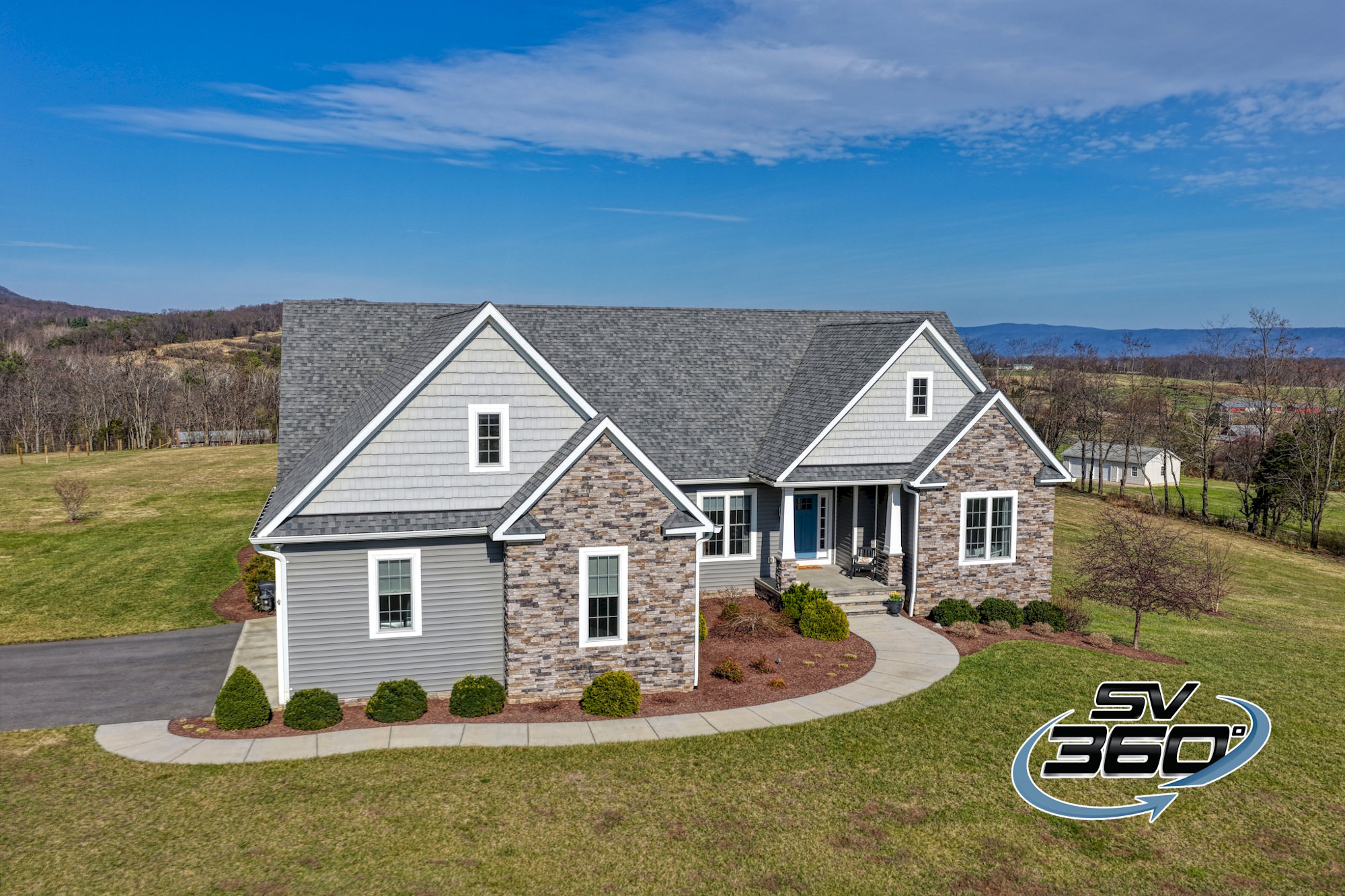 aerial-real-estate-listing drone photo of a luxury brick house in Shenandoah County